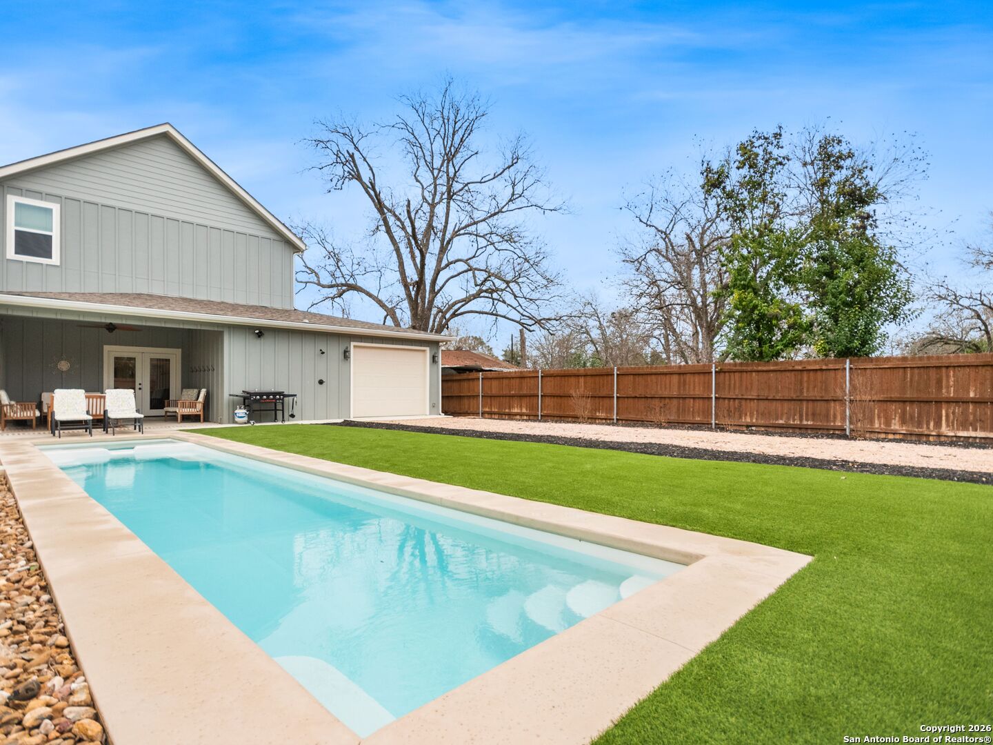 a view of an house with swimming pool and yard