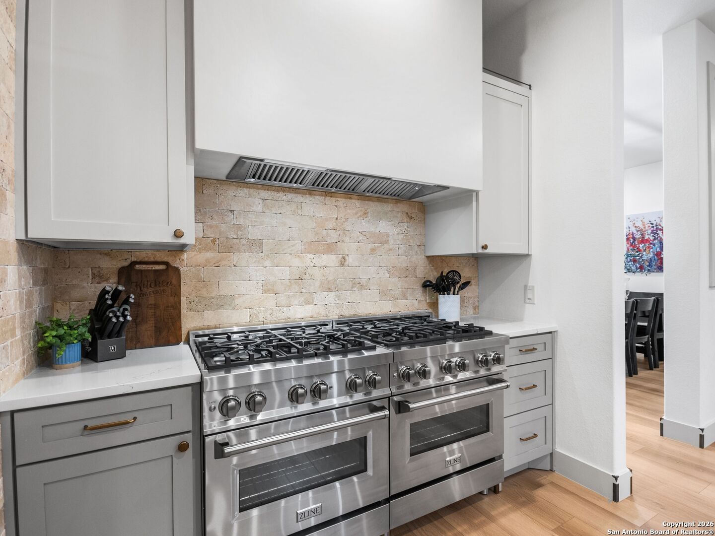 603 Graham Street Boerne, TX 78006 - Photo 17 of 42 a kitchen with stainless steel appliances granite countertop a stove and a white cabinets