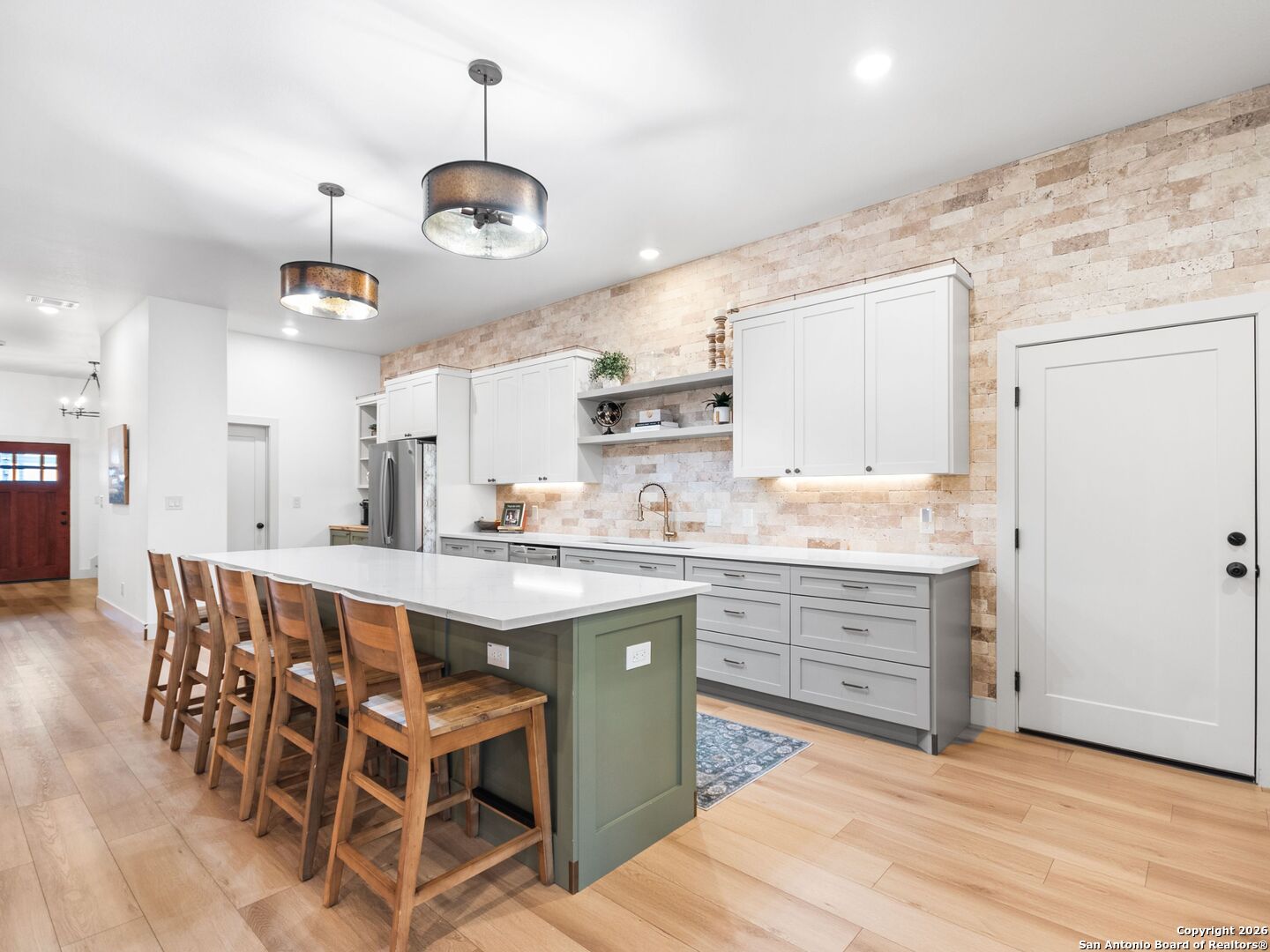 603 Graham Street Boerne, TX 78006 - Photo 2 of 42 a kitchen with stainless steel appliances a dining table chairs sink and cabinets