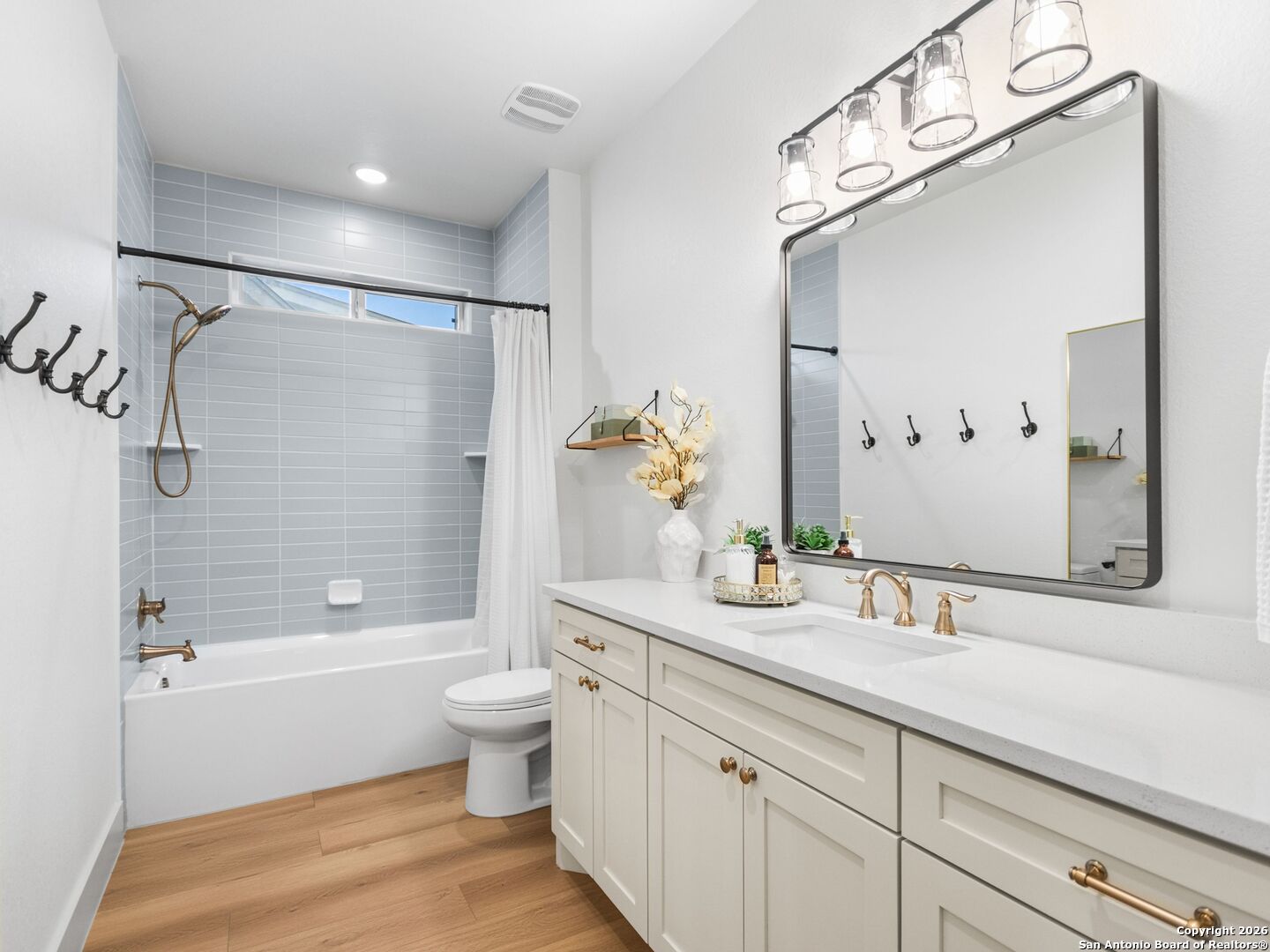 603 Graham Street Boerne, TX 78006 - Photo 31 of 42 a bathroom with a double vanity sink toilet mirror and shower