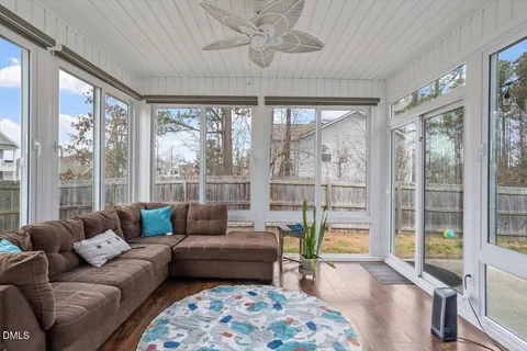 a living room with furniture and a ceiling fan
