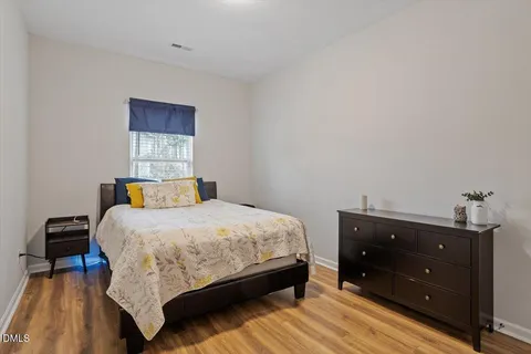 a spacious bedroom with a bed and window