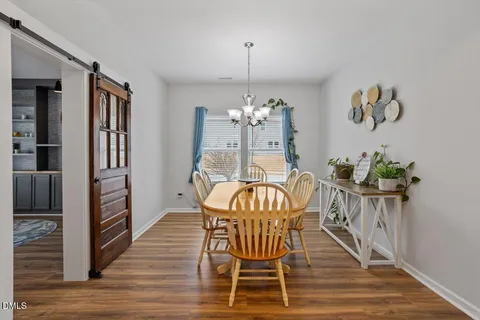 a view of a dining room with furniture wooden floor and a chandelier