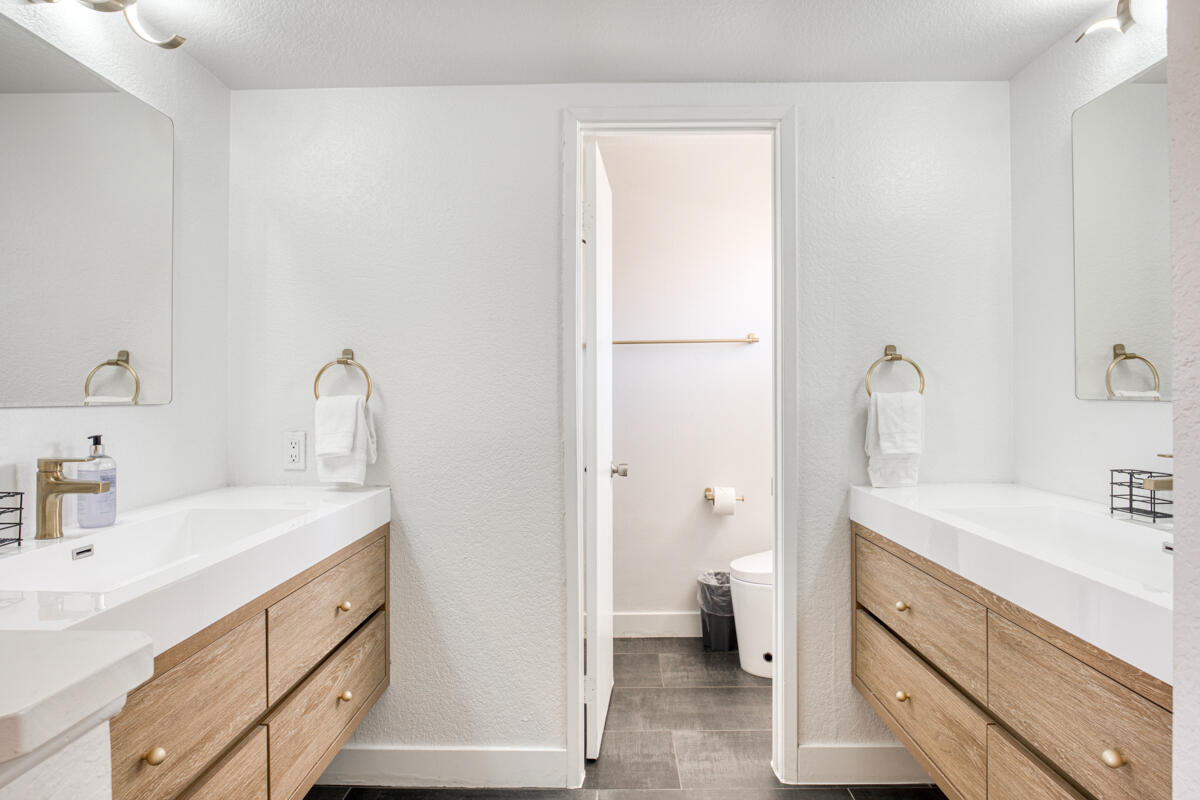 45640 Cimarron Road Indio, CA 92201 - Photo 16 of 28 a bathroom with a sink a toilet and a large mirror