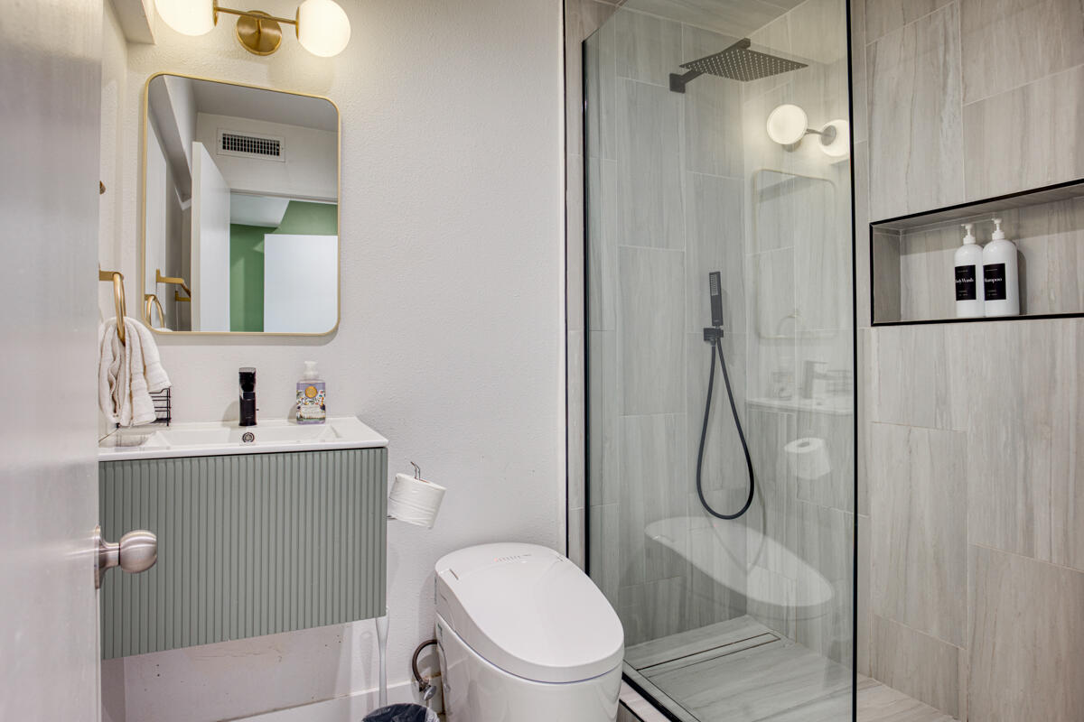 45640 Cimarron Road Indio, CA 92201 - Photo 18 of 28 a bathroom with a toilet sink vanity and shower