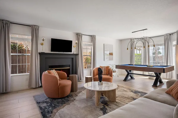 a living room with furniture a fireplace and a flat screen tv
