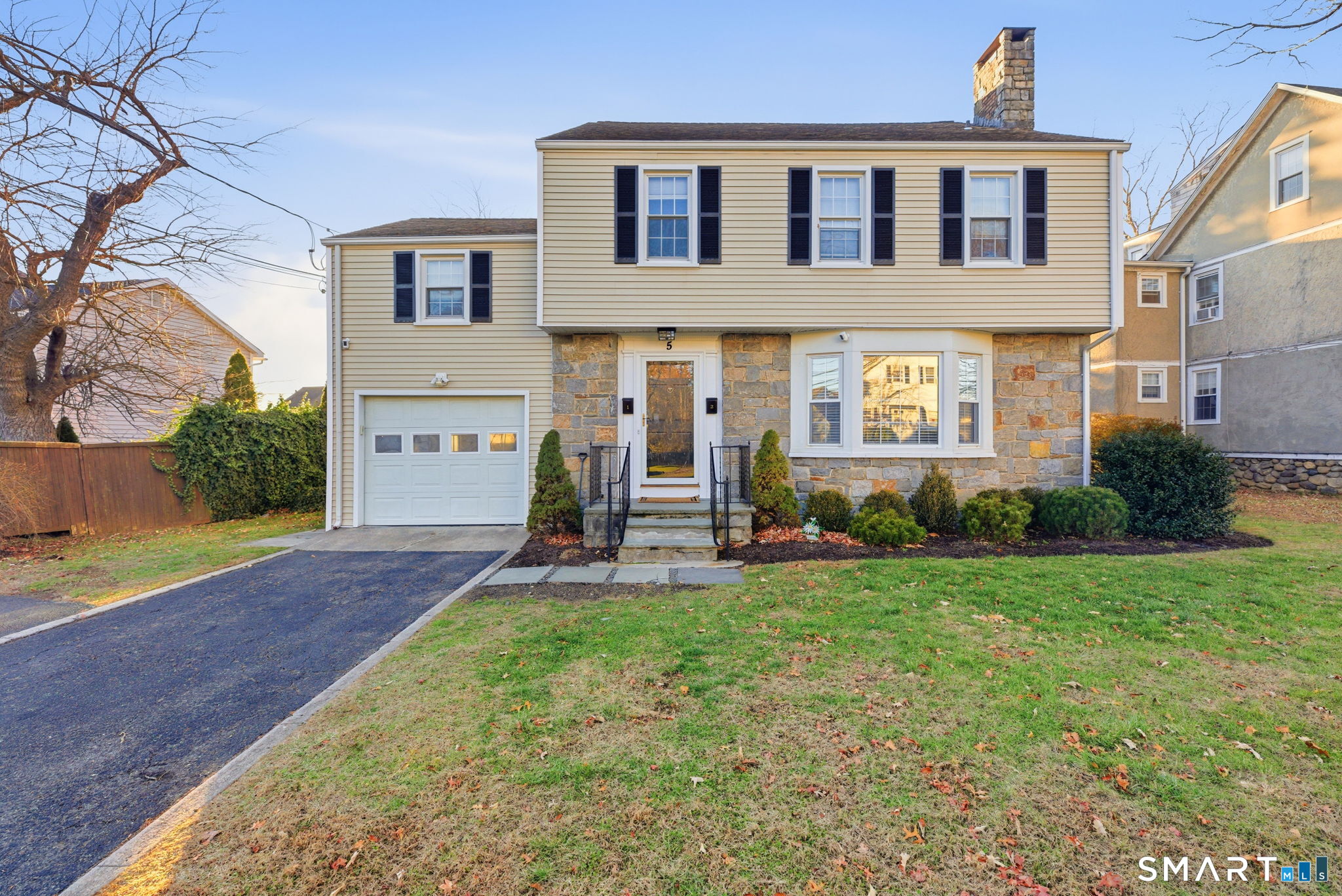 a view of a house with a yard and sitting area
