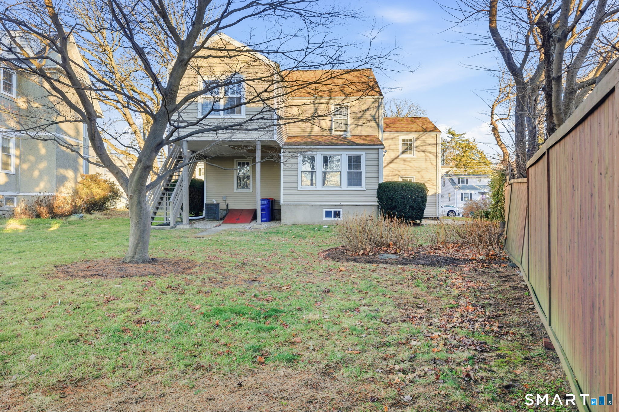 5 Bridge Street Norwalk, CT 06855 - Photo 11 of 11 a view of a house with a small yard and large tree