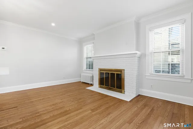 wooden floor fireplace and natural light in room