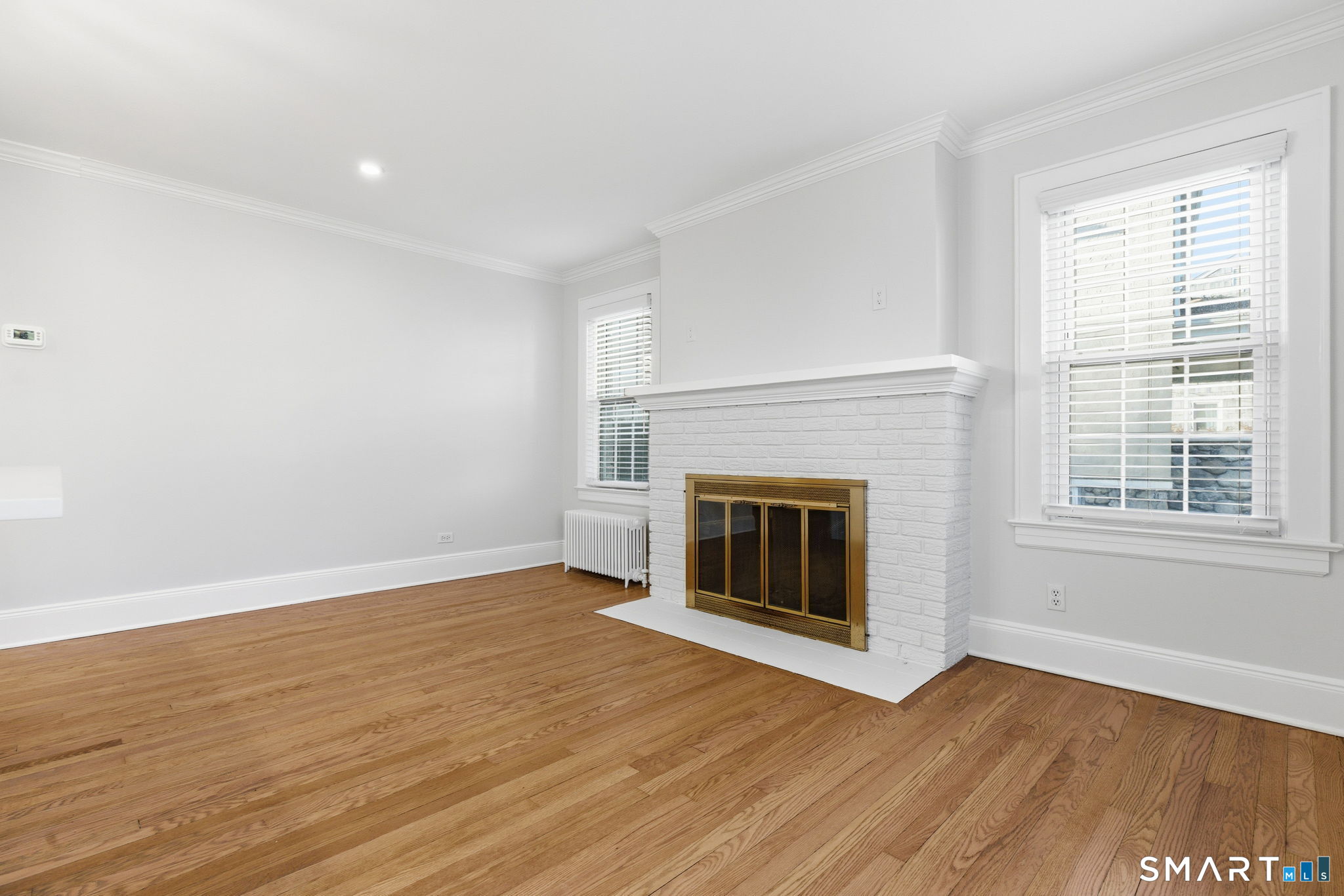 5 Bridge Street Norwalk, CT 06855 - Photo 4 of 11 wooden floor fireplace and natural light in room