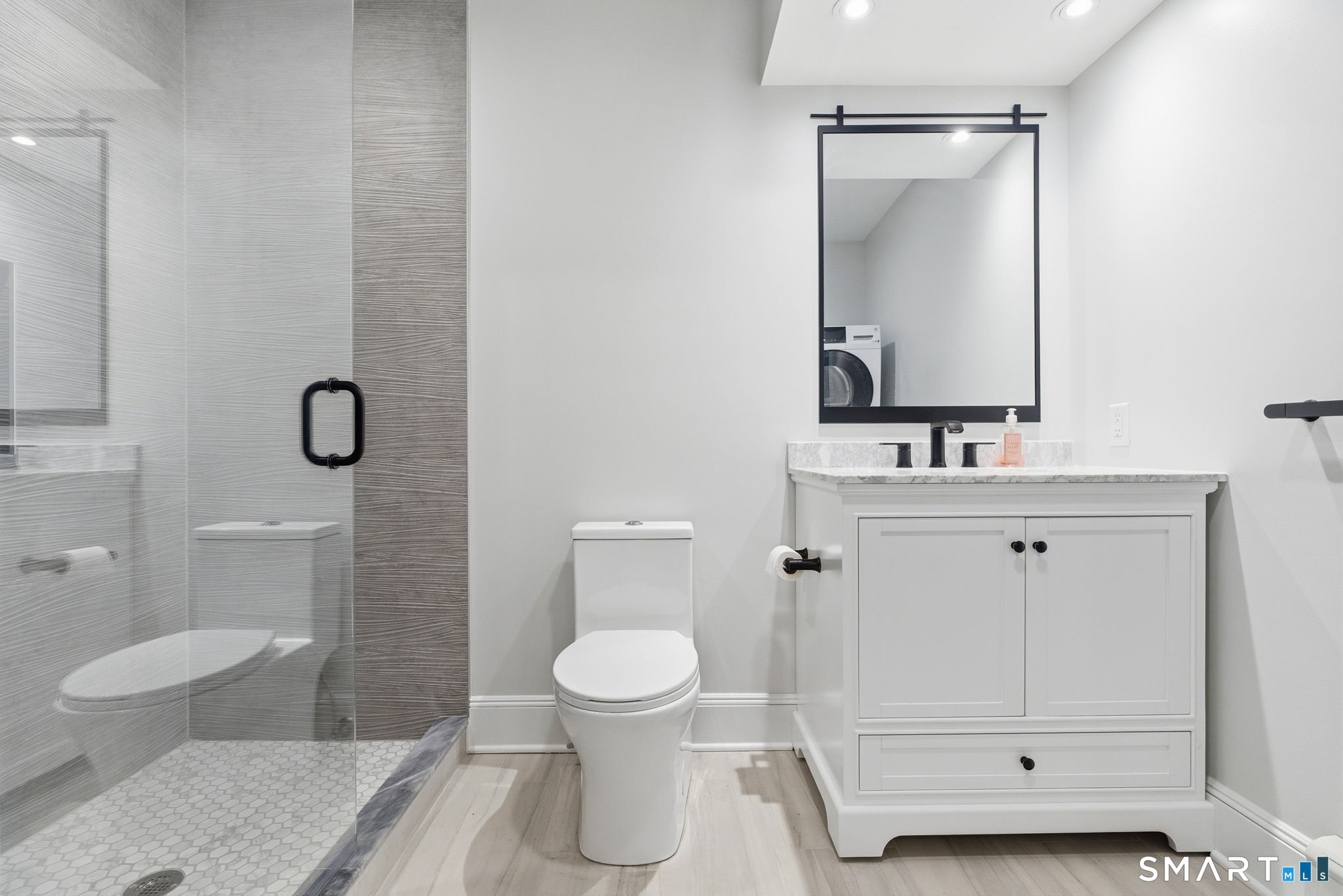 5 Bridge Street Norwalk, CT 06855 - Photo 7 of 11 a bathroom with a toilet sink vanity and mirror