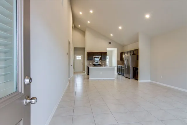 a view of a living room and entry way to kitchen