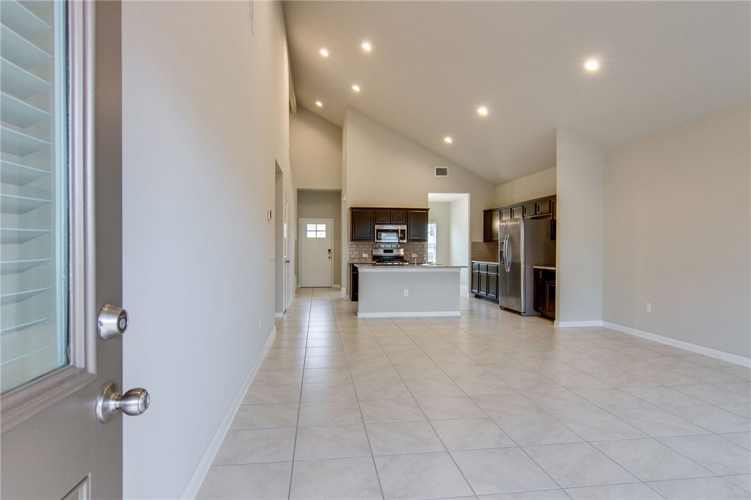6916 Ranchito Drive Austin, TX 78744 - Photo 11 of 37 a view of a living room and entry way to kitchen