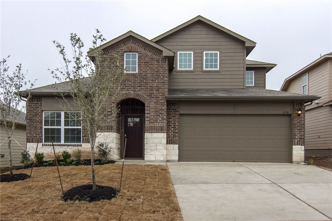 6916 Ranchito Drive Austin, TX 78744 - Photo 2 of 37 a front view of a house with garden