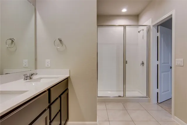 a bathroom with a shower sink and mirror