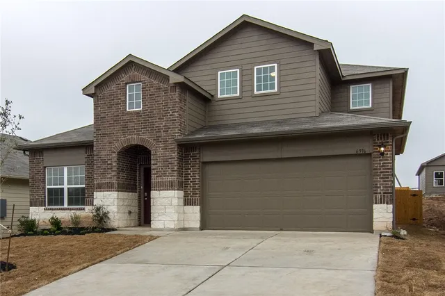 a front view of a house with garage