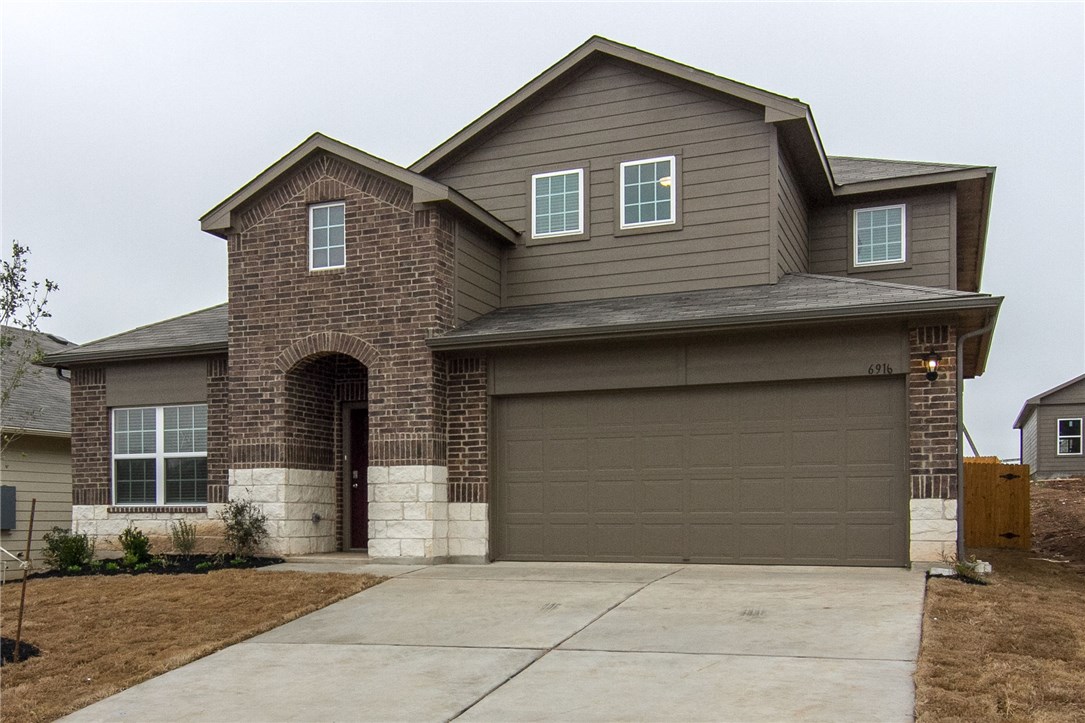 6916 Ranchito Drive Austin, TX 78744 - Photo 3 of 37 a front view of a house with garage