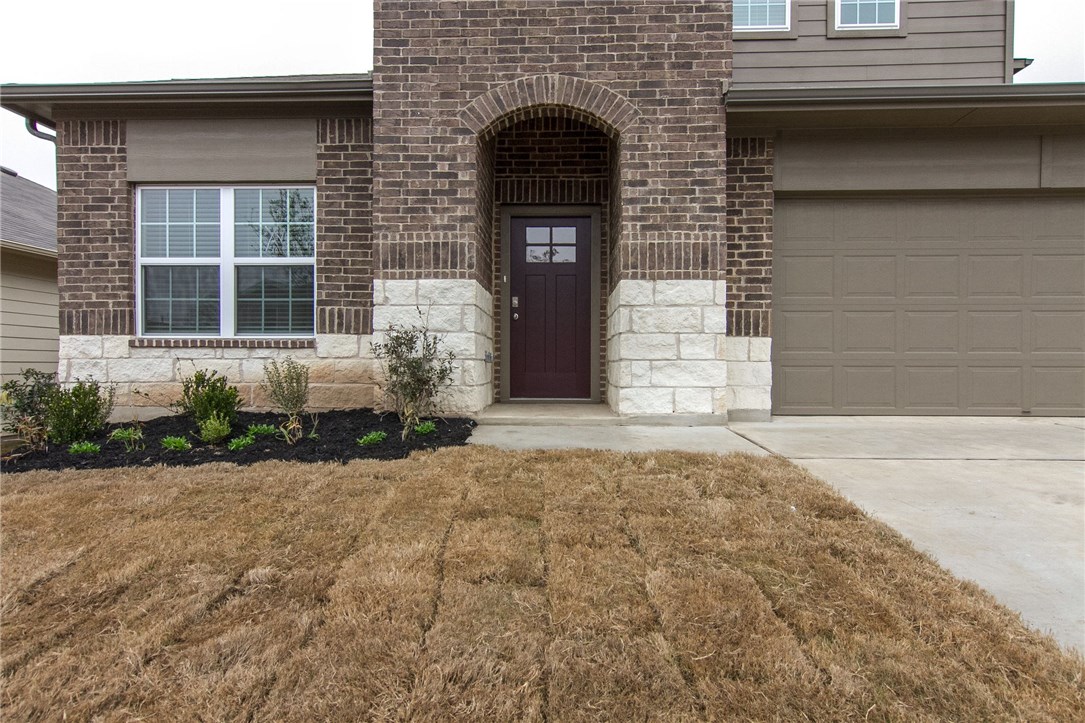 6916 Ranchito Drive Austin, TX 78744 - Photo 4 of 37 a front view of a house with a yard