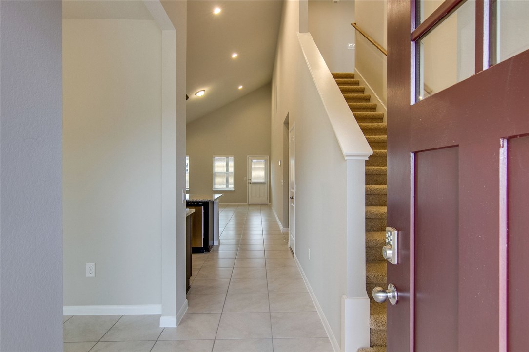 6916 Ranchito Drive Austin, TX 78744 - Photo 5 of 37 a view of a hallway with wooden floor and staircase