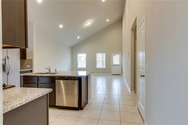 a kitchen with a sink a counter top space and appliances