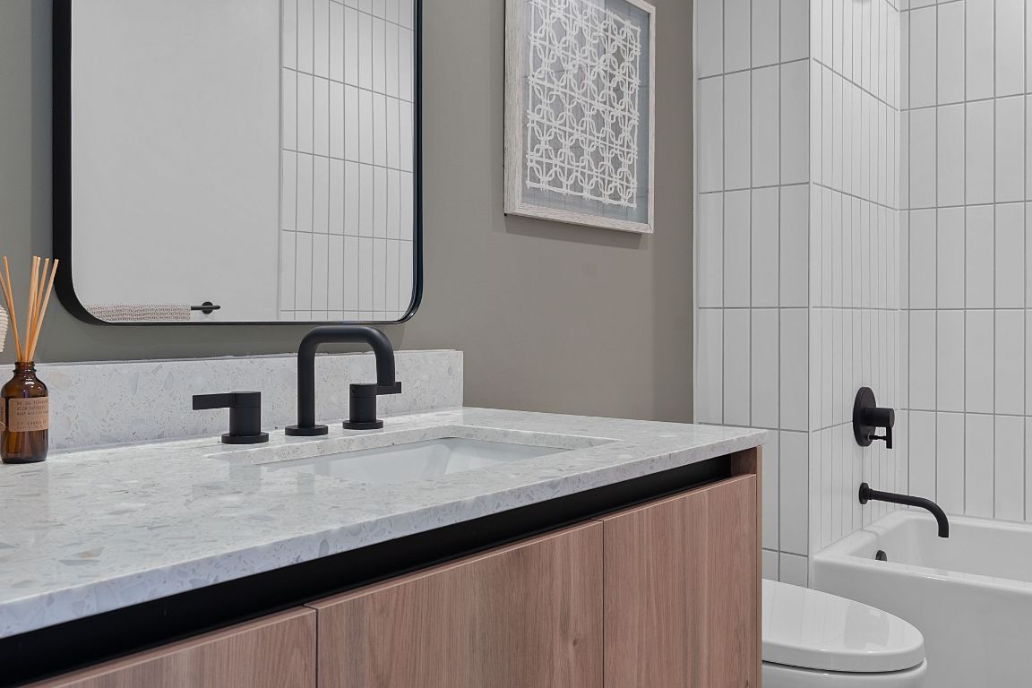 84 East Avenue, Unit 2410 Austin, TX 78701 - Photo 20 of 40 Representative of Property. Full bathroom featuring vanity and shower combination