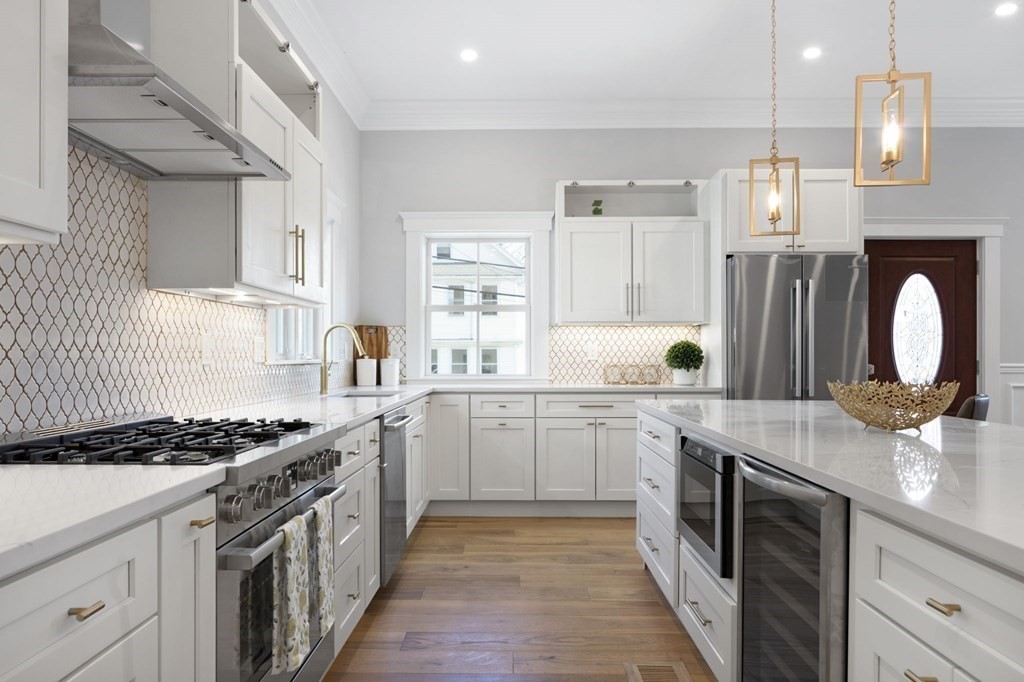 9 Whitford Street, Unit 9 Boston, MA 02131 - Photo 1 of 25 a kitchen with stainless steel appliances granite countertop a sink stove refrigerator and cabinets