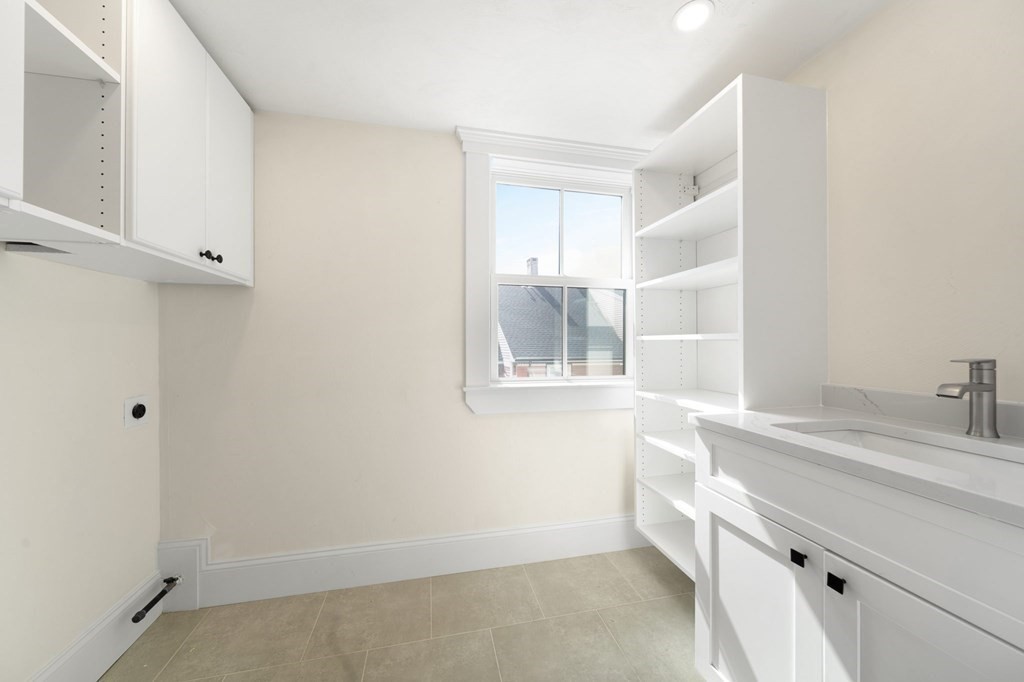 9 Whitford Street, Unit 9 Boston, MA 02131 - Photo 15 of 25 a view of a kitchen cabinets a sink and a window