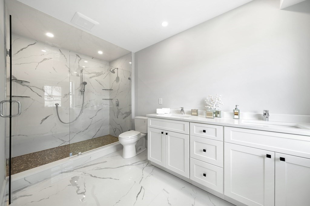 9 Whitford Street, Unit 9 Boston, MA 02131 - Photo 17 of 25 a bathroom with a granite countertop sink toilet and shower