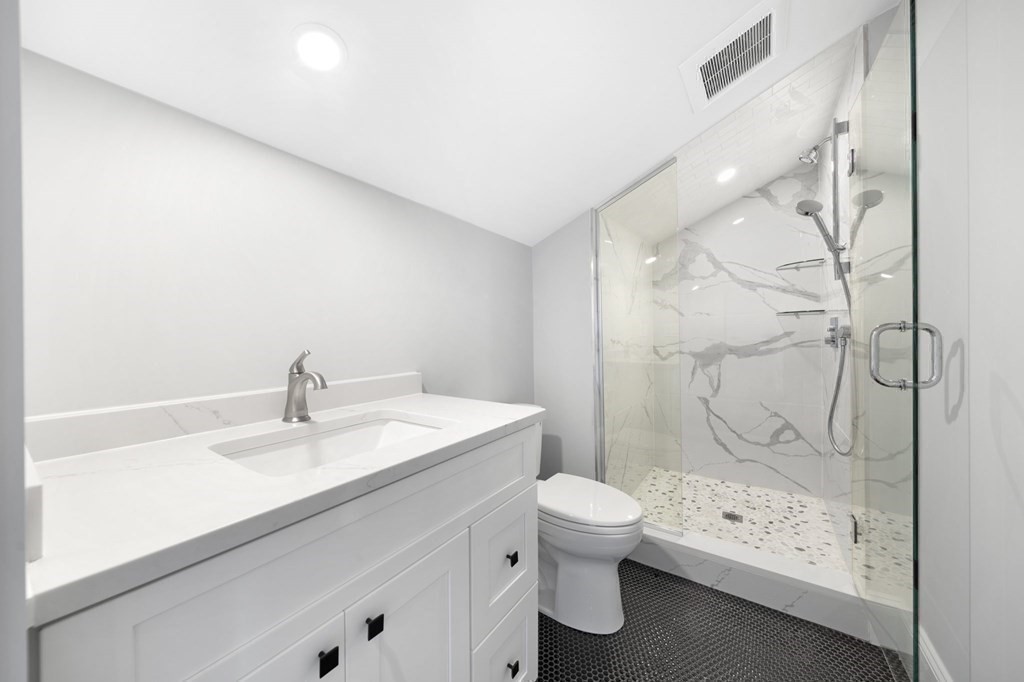 9 Whitford Street, Unit 9 Boston, MA 02131 - Photo 23 of 25 a bathroom with a sink a toilet and shower