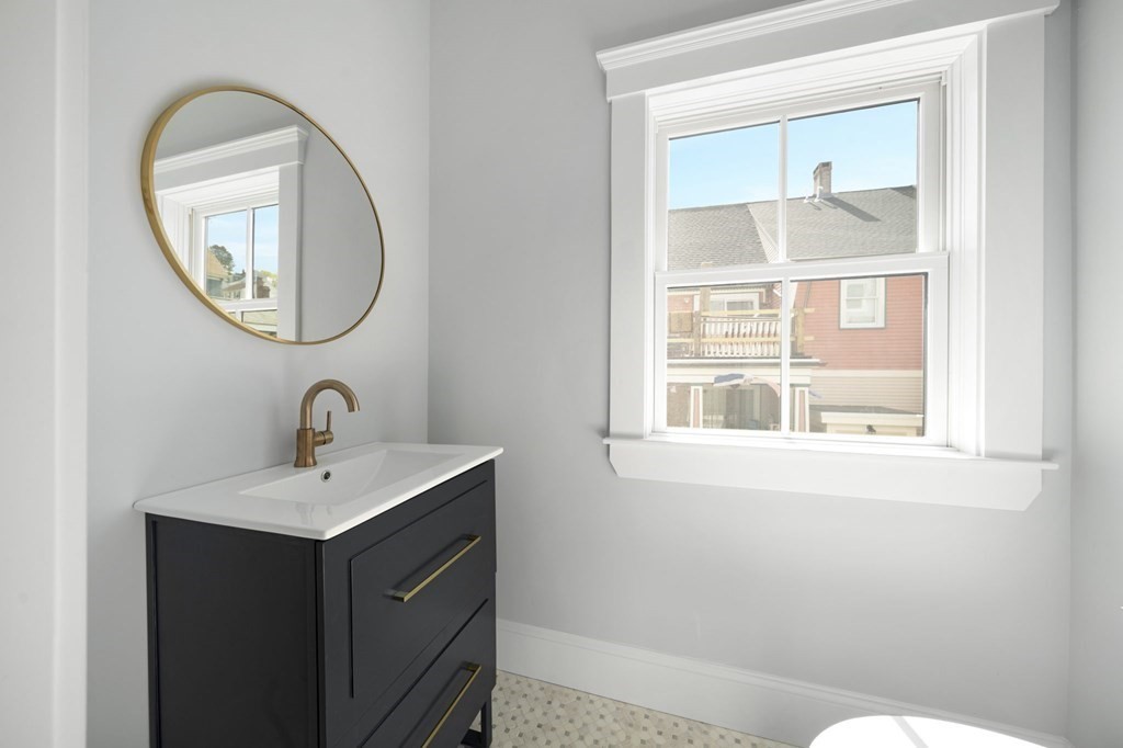 9 Whitford Street, Unit 9 Boston, MA 02131 - Photo 8 of 25 a bathroom with a sink and a mirror