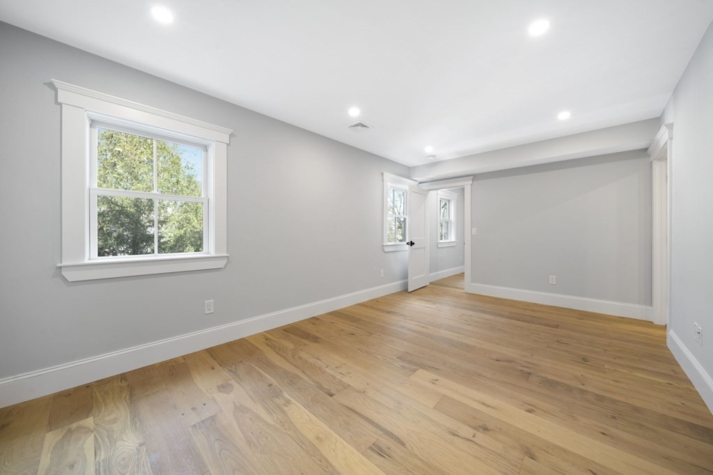 9 Whitford Street, Unit 9 Boston, MA 02131 - Photo 10 of 25 a view of an empty room with wooden floor and a window