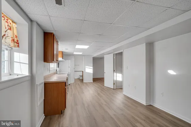 a view of empty room with wooden floor