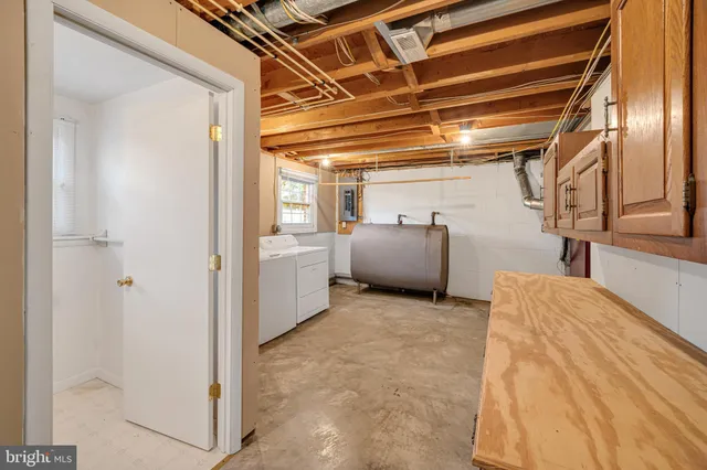 a view of storage and utility room with refrigerator and windows