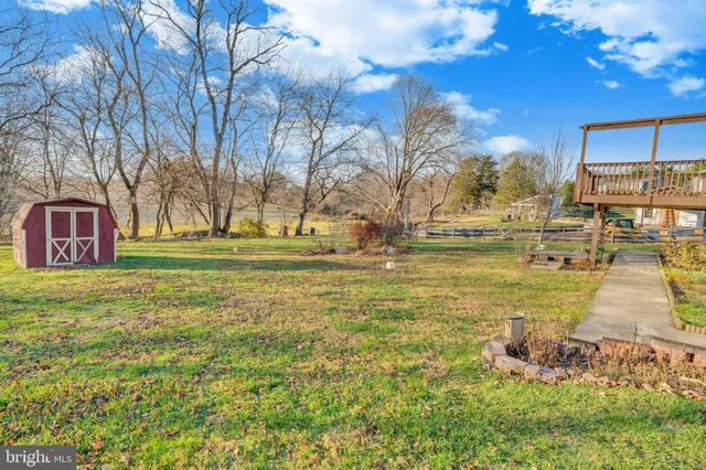 a swimming pool with outdoor seating and yard