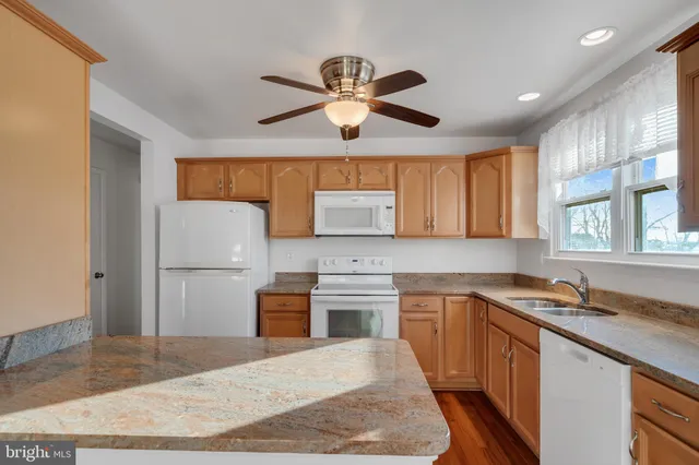 a kitchen with a stove a sink and a refrigerator