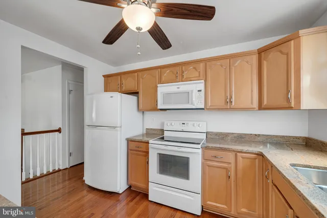 a kitchen with a refrigerator sink and cabinets