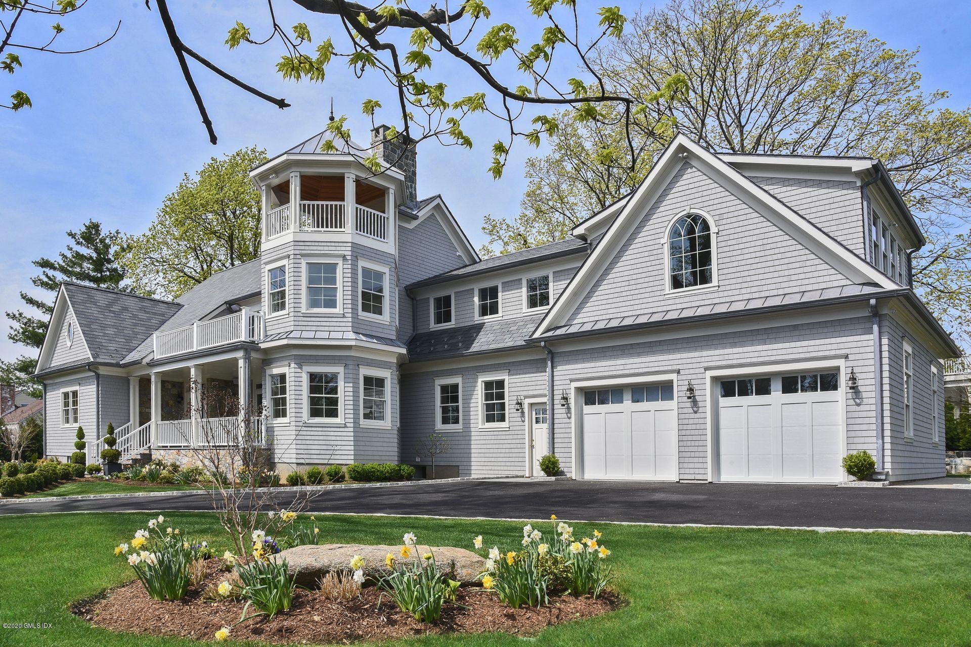 154 Byram Shore Road Greenwich, CT 06830 - Photo 1 of 37 a front view of a house with a garden