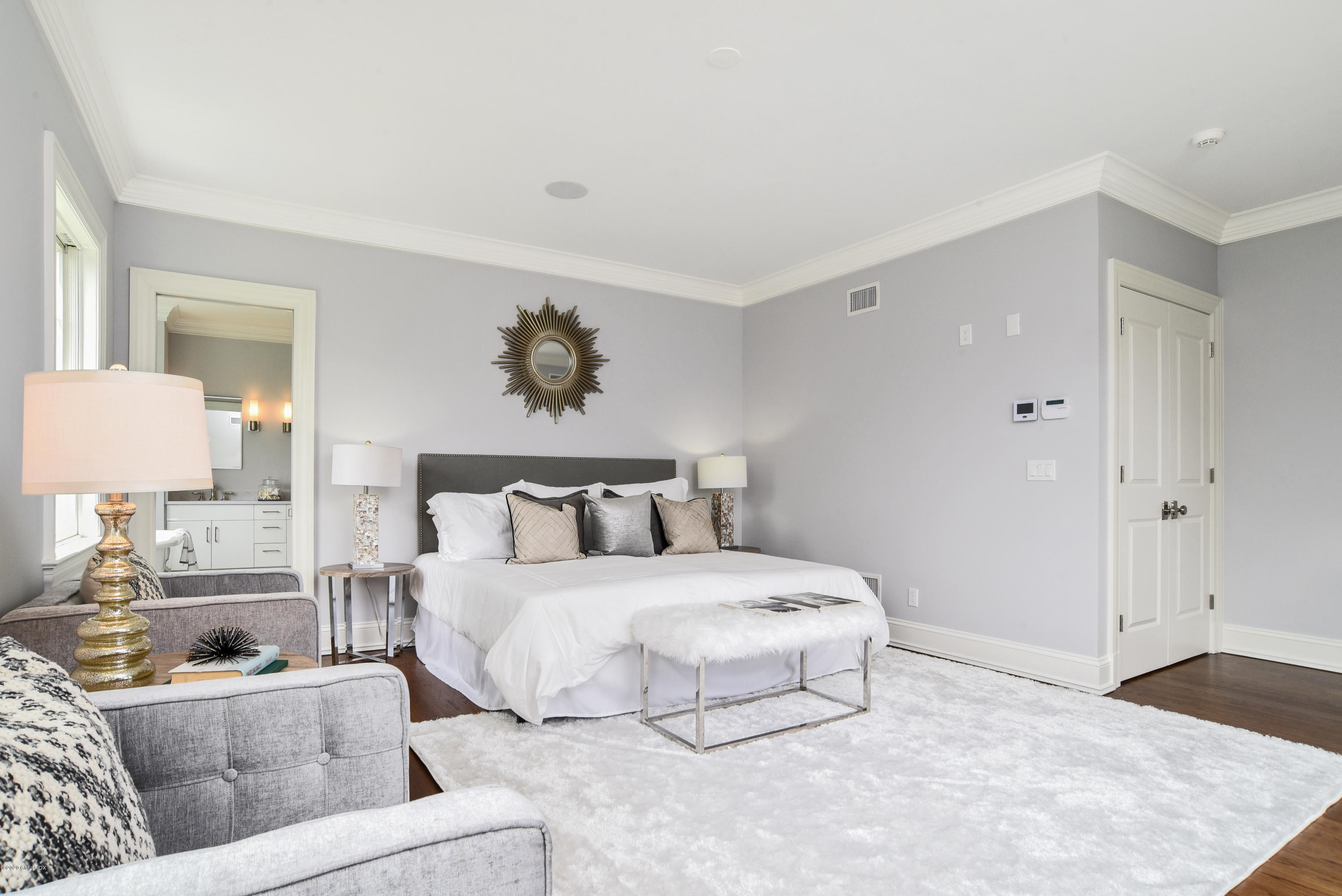 154 Byram Shore Road Greenwich, CT 06830 - Photo 13 of 37 a bedroom with a large bed and a couch