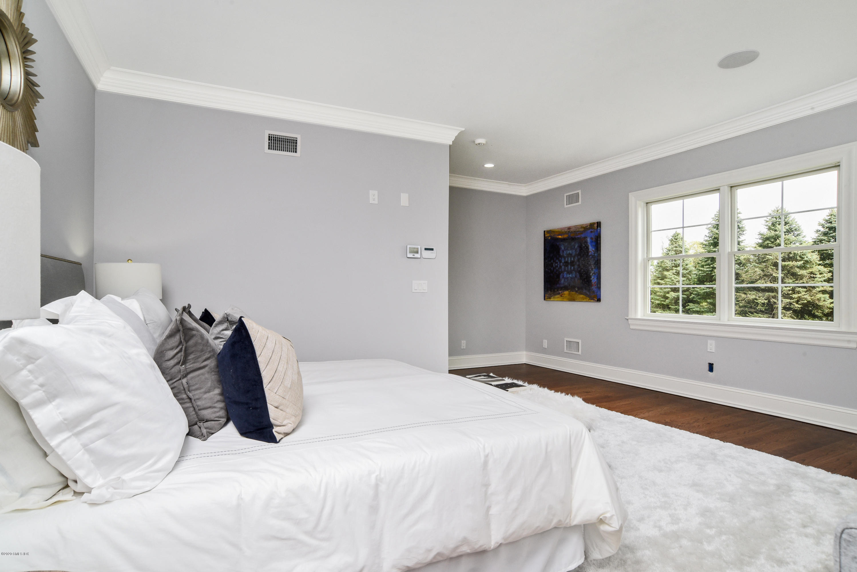 154 Byram Shore Road Greenwich, CT 06830 - Photo 14 of 37 a bedroom with a bed and a large window