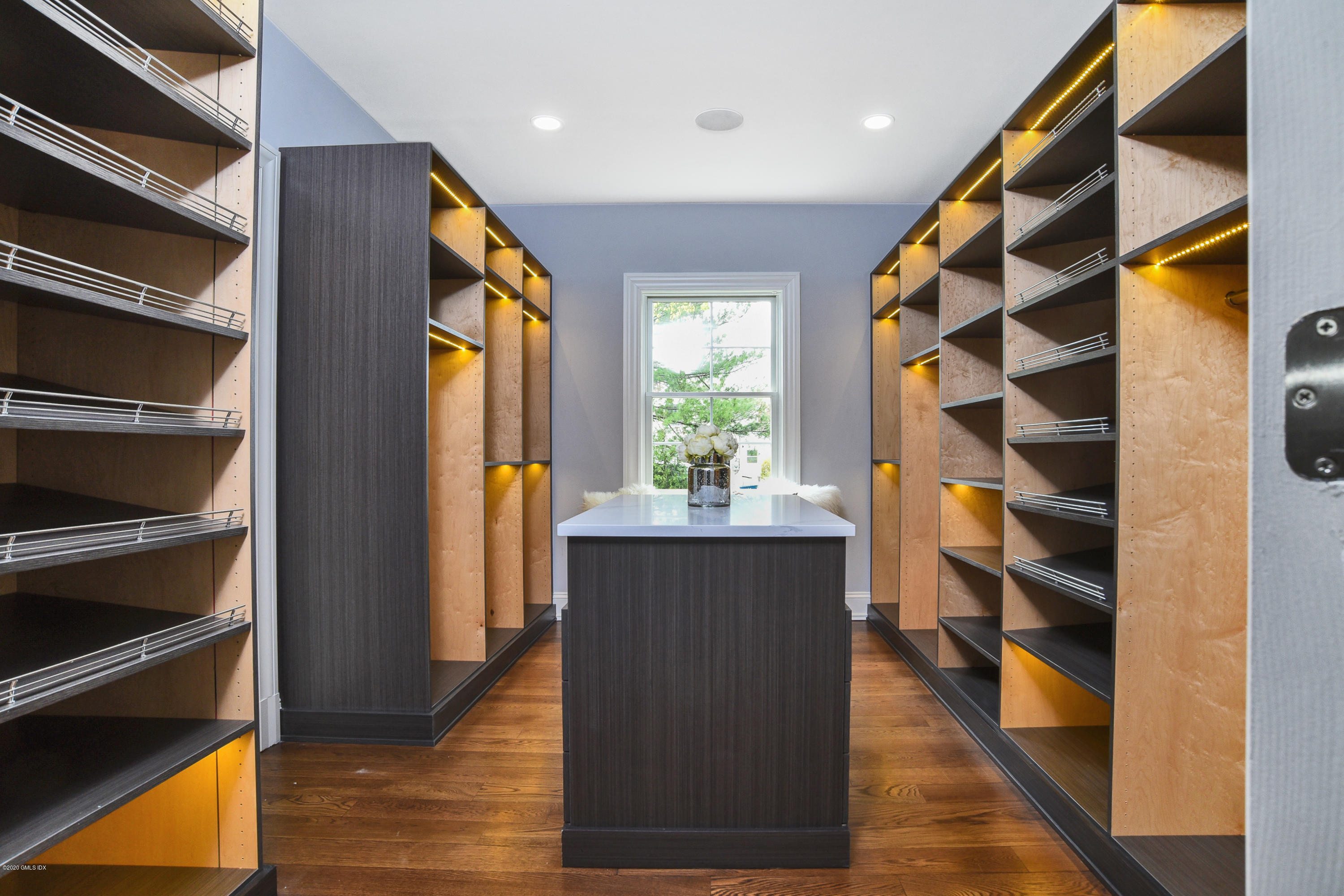 154 Byram Shore Road Greenwich, CT 06830 - Photo 17 of 37 a view of walk in closet with wooden floor and windows