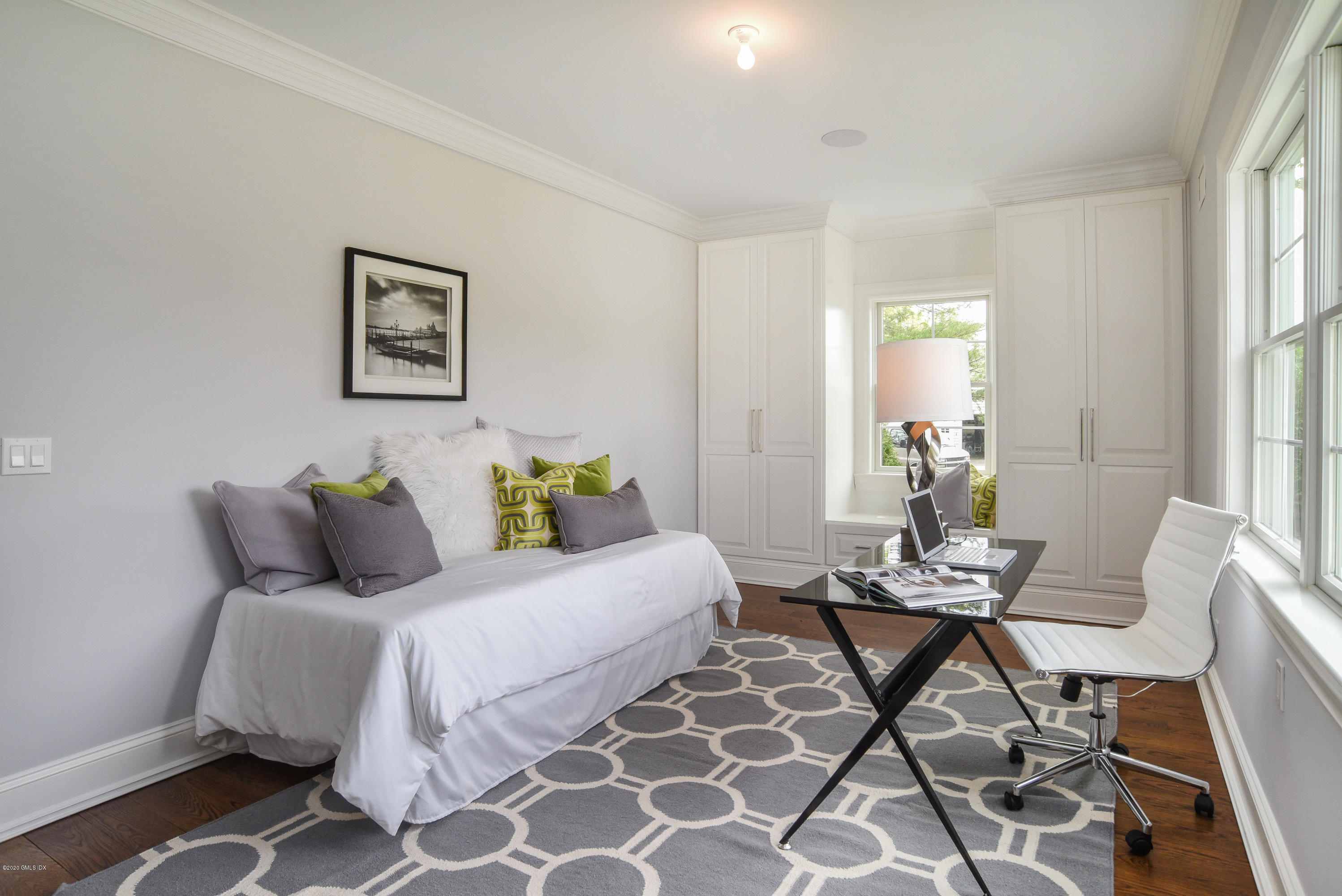 154 Byram Shore Road Greenwich, CT 06830 - Photo 18 of 37 a bedroom with a bed and wooden floor