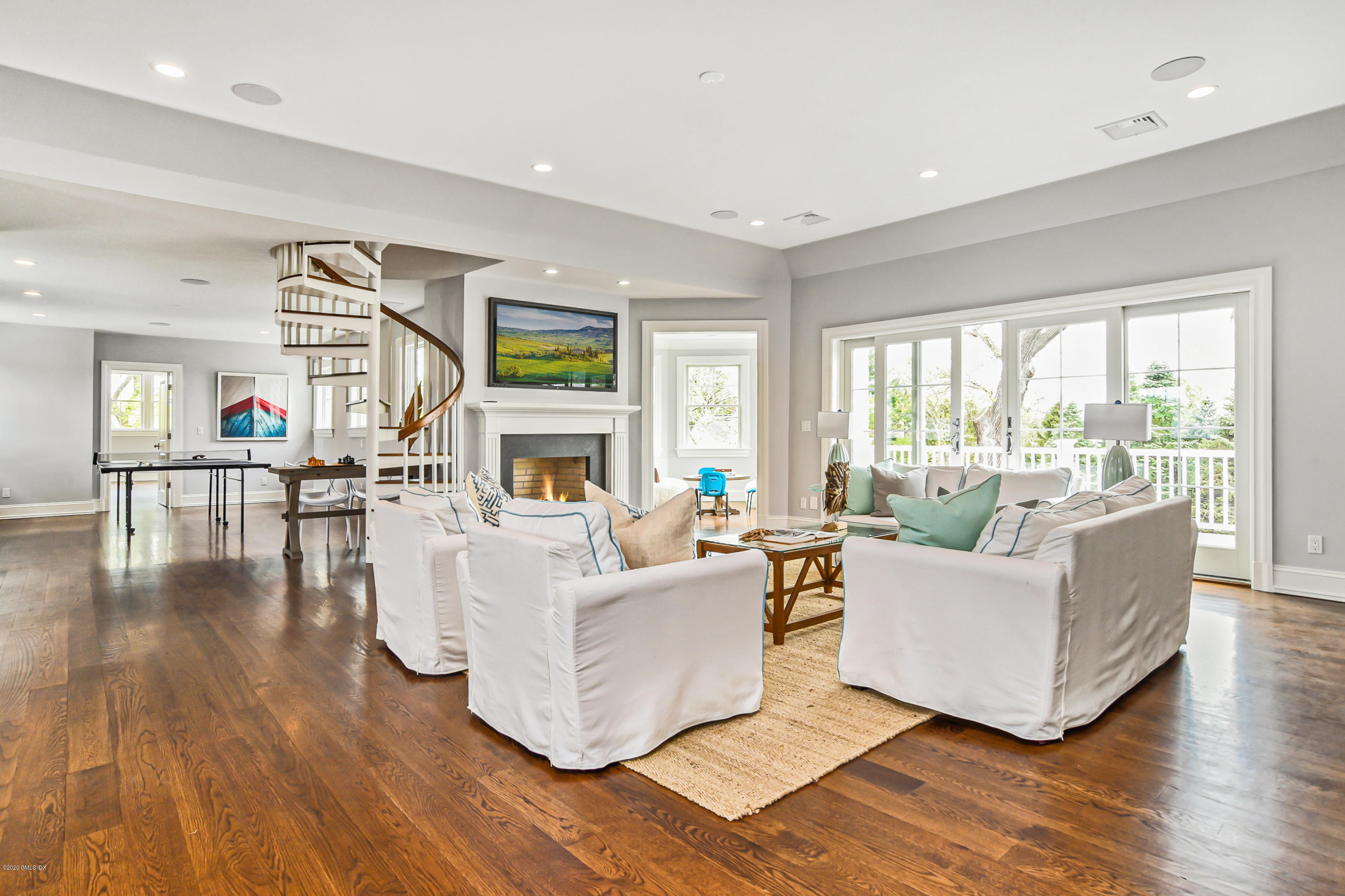 154 Byram Shore Road Greenwich, CT 06830 - Photo 20 of 37 a living room with fireplace furniture and a large window