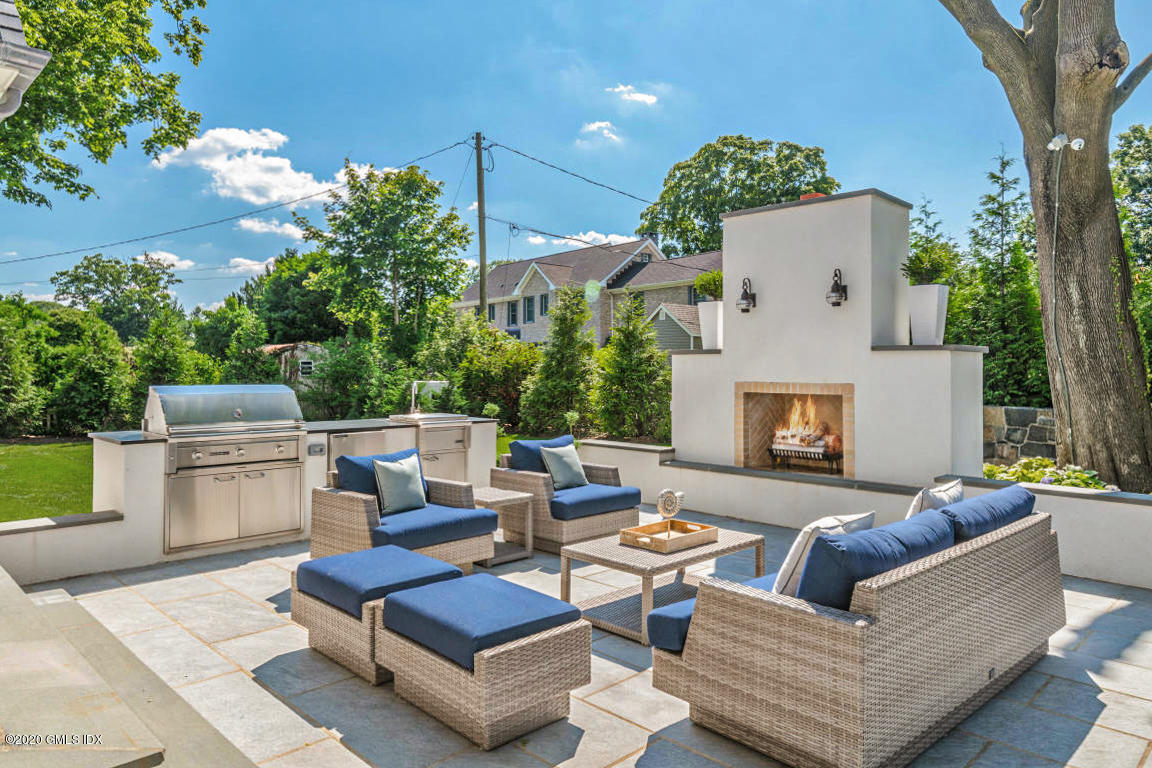 154 Byram Shore Road Greenwich, CT 06830 - Photo 2 of 37 a outdoor living space with furniture potted plant and a fireplace