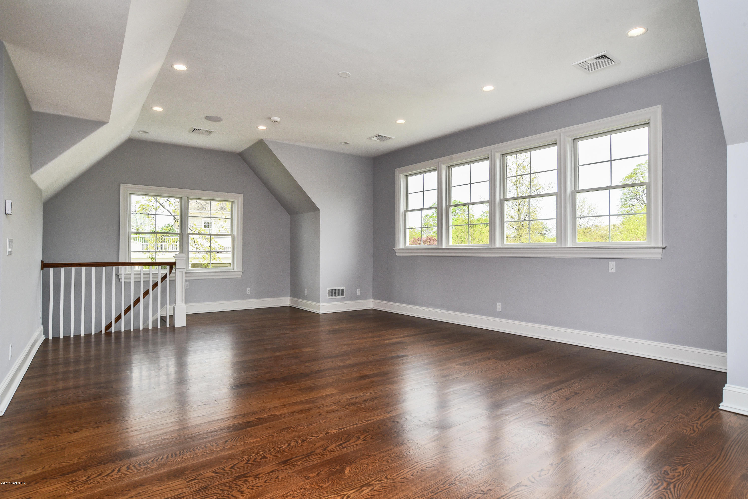 154 Byram Shore Road Greenwich, CT 06830 - Photo 24 of 37 an empty room with wooden floor and windows