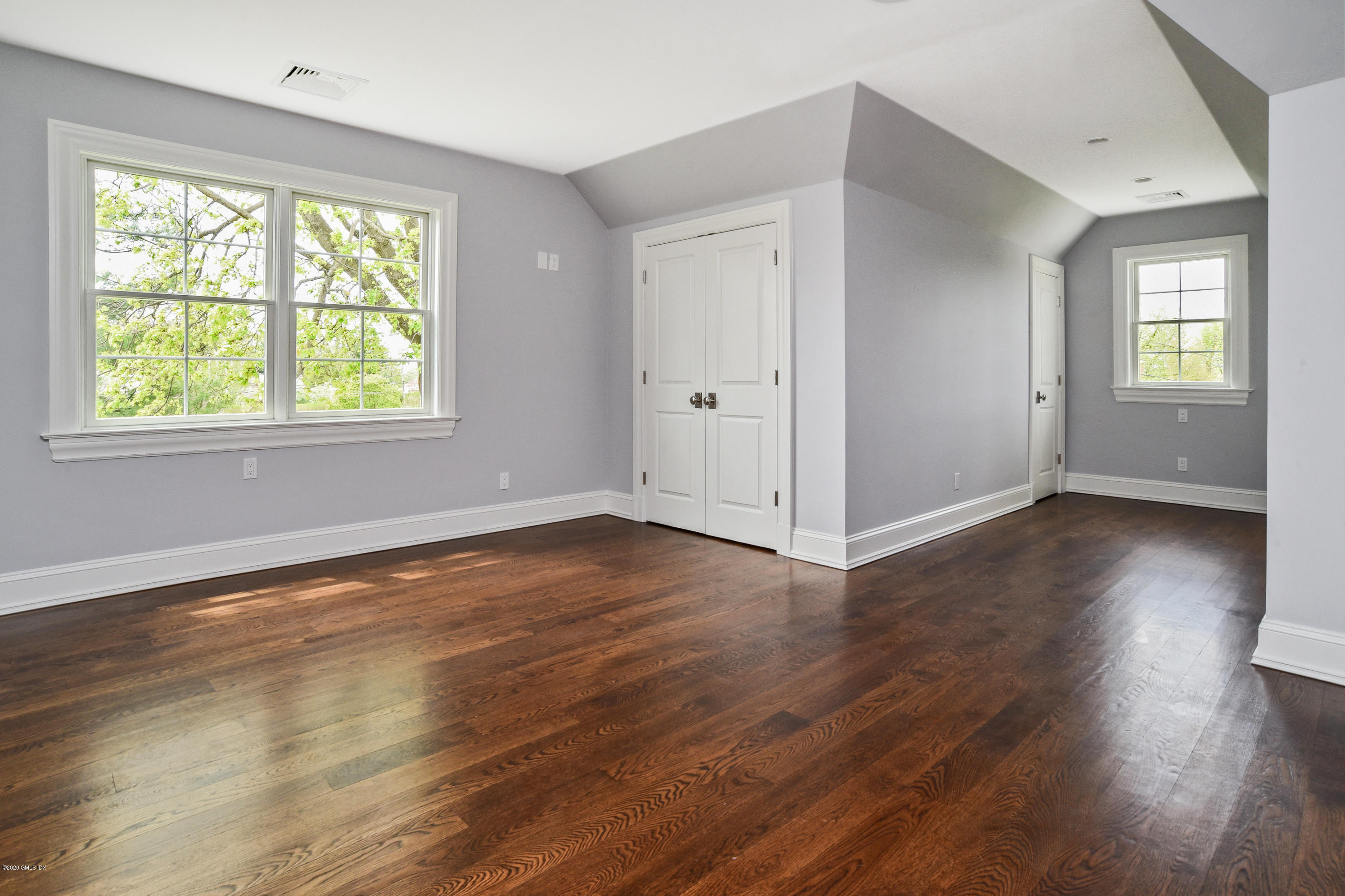 154 Byram Shore Road Greenwich, CT 06830 - Photo 25 of 37 an empty room with wooden floor and windows