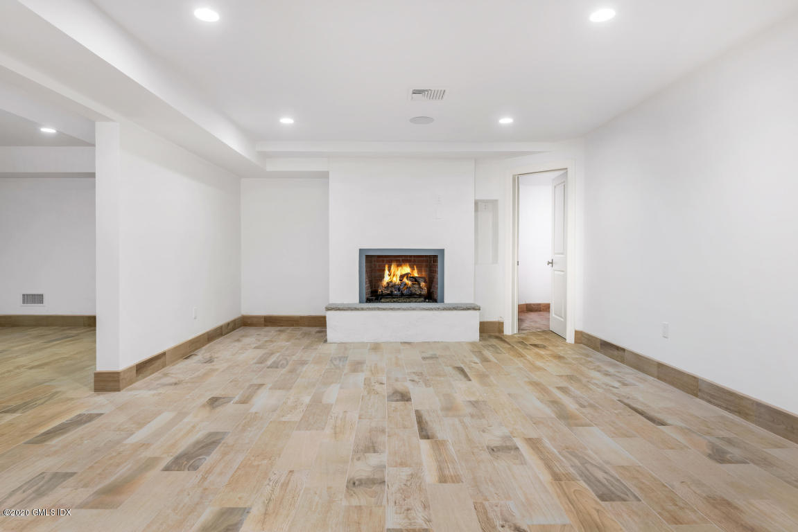 154 Byram Shore Road Greenwich, CT 06830 - Photo 26 of 37 a view of an empty room with wooden floor and windows
