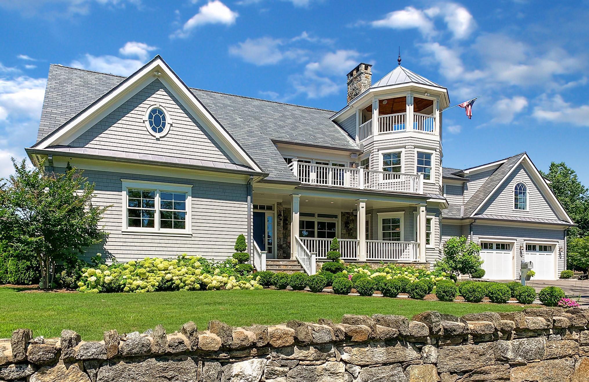 154 Byram Shore Road Greenwich, CT 06830 - Photo 3 of 37 a front view of a house with a yard