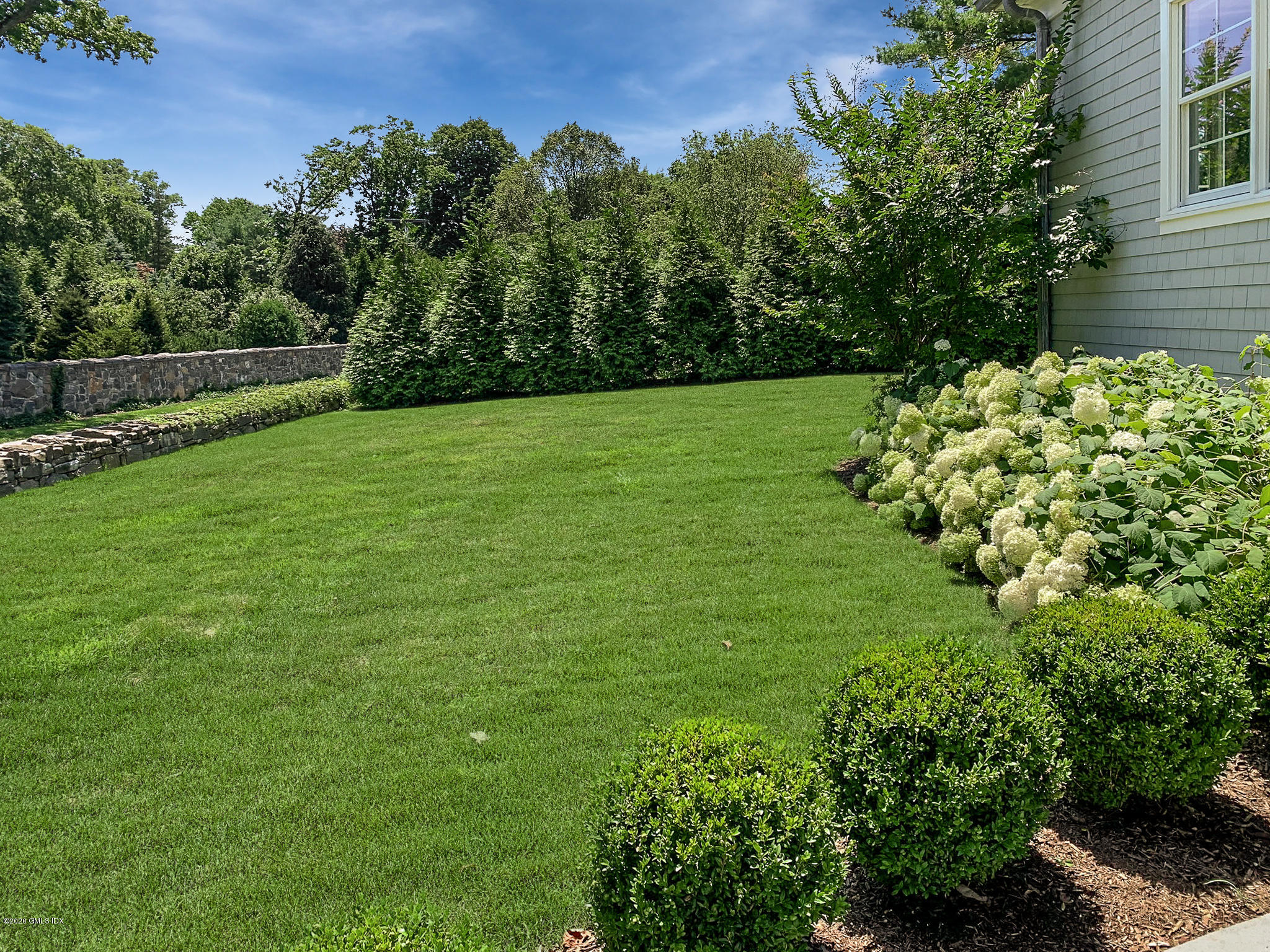 154 Byram Shore Road Greenwich, CT 06830 - Photo 32 of 37 a view of a garden with a flower in a garden