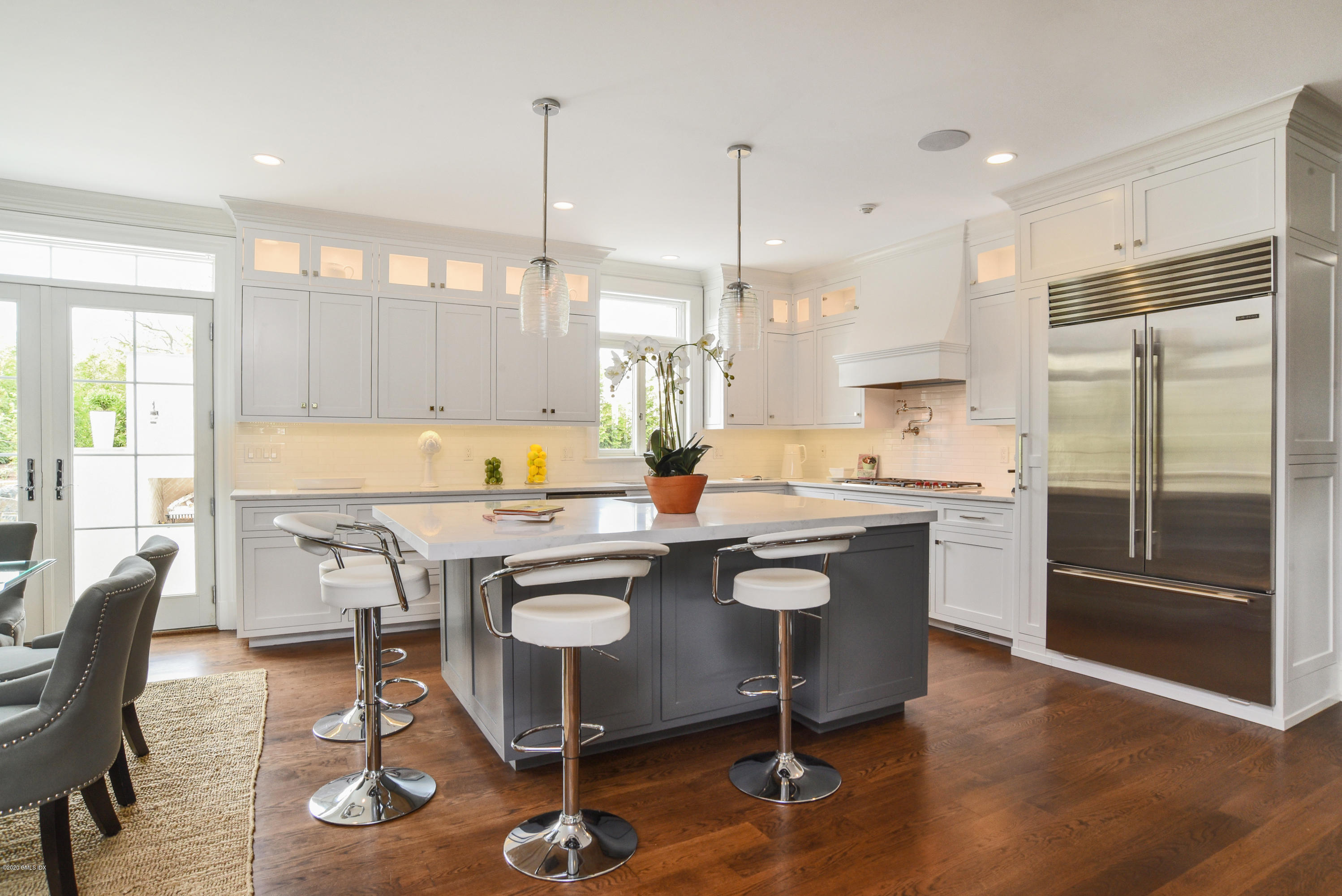 154 Byram Shore Road Greenwich, CT 06830 - Photo 8 of 37 a kitchen with a table chairs stove and cabinets