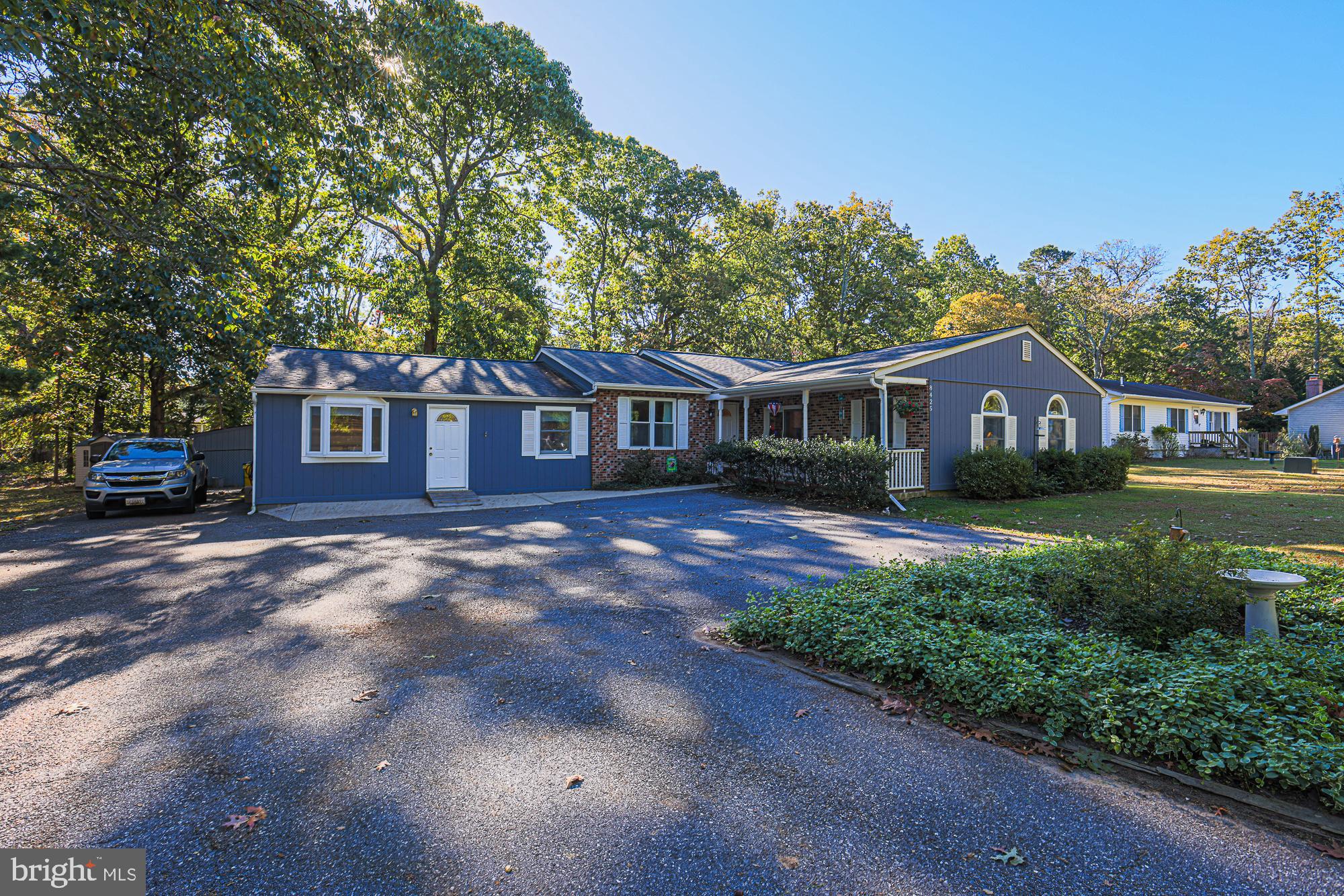 a front view of a house with yard and green space